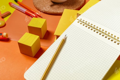 Preview: Creative workspace with blank notebook and colorful stationery on yellow background