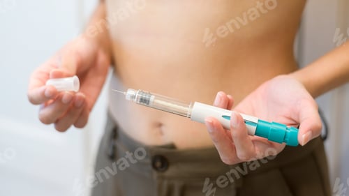Preview: woman using IVF treatment injection on belly to prepare reproductive fertility