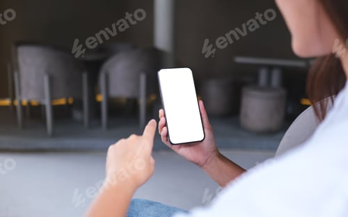Preview: Mockup image of a woman holding and using mobile phone with blank desktop screen in cafe