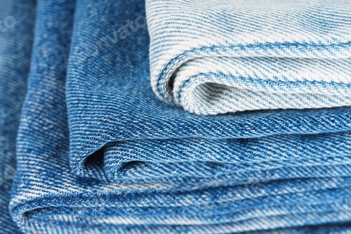 Preview: Pile Of Textiles In Various Shades Of Blue, Stacked Jeans Fabric On Top Of Each Other In Store