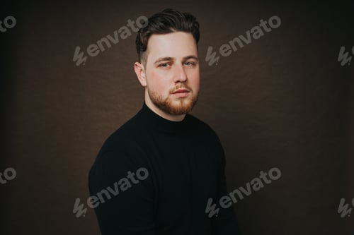 Preview: Portrait of a young Caucasian confident man posing in a studio
