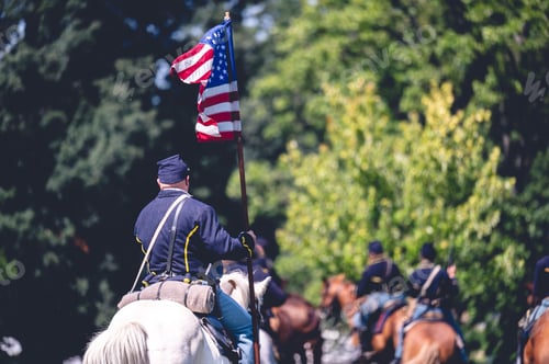 Preview: Soldier riding a horse and raises the flag of America during military performance