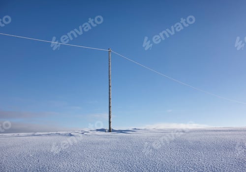 Preview: Wooden electric pole on empty snow covered landscape. Electrical industry, power line.