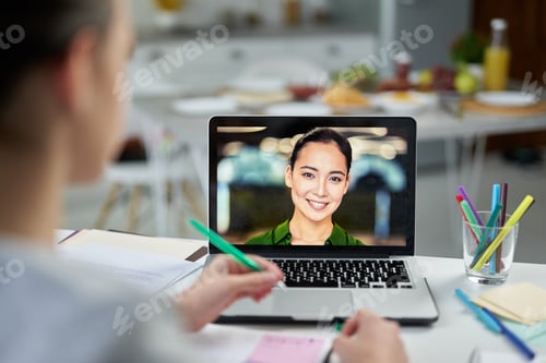 Preview: Online study partner. Attractive young female teacher smiling to her students, using video chat app