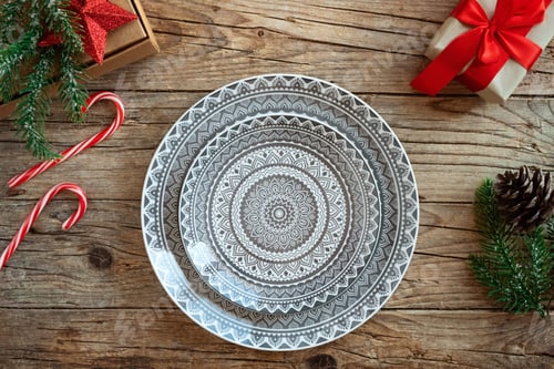 Preview: Creative Christmas table setting. Empty plates on rustic wooden xmas background.