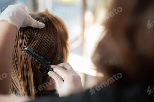 Preview: woman client person having a process to making treatment a hair with hairdresser in beauty salon