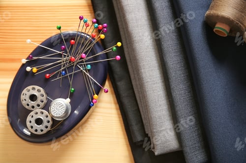 Preview: Composition with fabrics and accessories for tailoring on wooden background