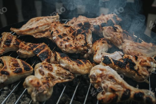 Preview: Closeup shot of meat roasting on a charcoal grill