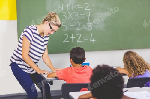 Preview: Teacher teaching mathematics to school kids in classroom