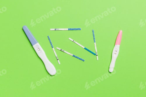 Preview: Colored Pregnancy test on colored background, top view with copy space