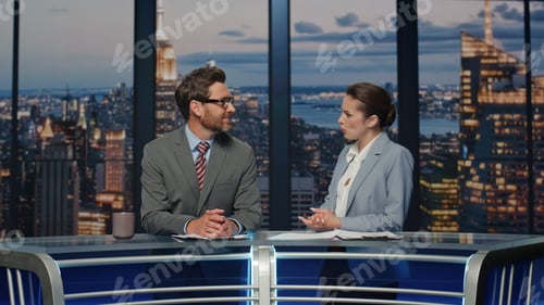 Preview: Couple anchors discussing news standing night television channel studio closeup