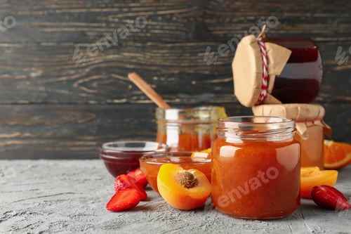 Preview: Composition with jam and ingredients on gray table, space for text
