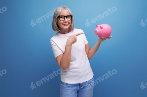 Preview: grandmother with gray hair thinks where to invest her savings on a studio background with copy space
