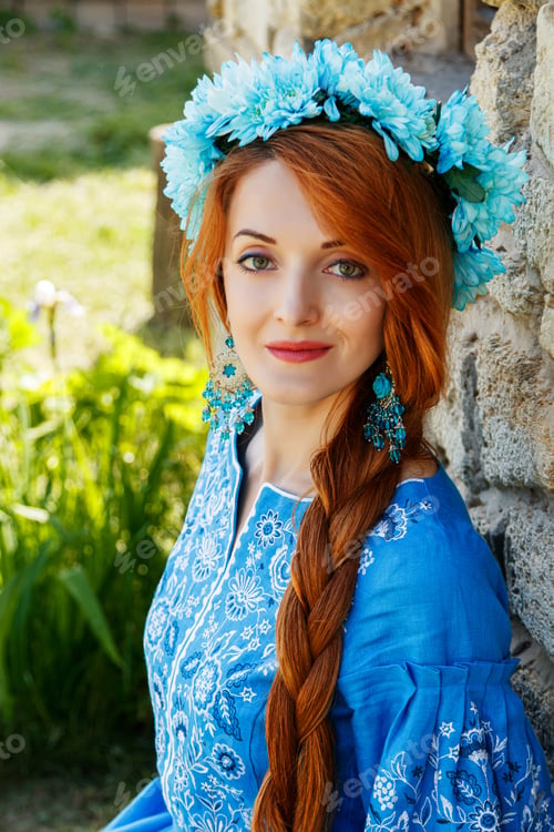 Preview: Beautiful red-haired girl in a blue dress (Ukrainian) with a wreath on her head