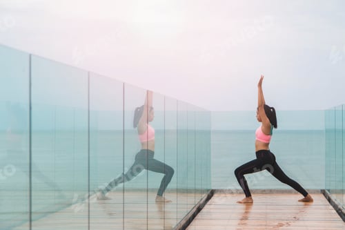 Preview: Woman doing yoga with beach view.