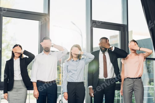Preview: obscured view of multiethnic businesspeople covering eyes in conference hall