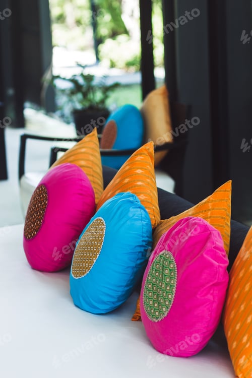 Preview: Multicolor round pillows on sofa