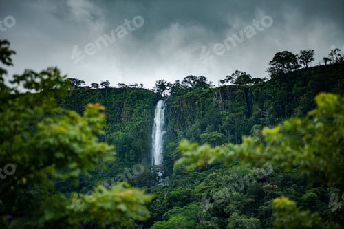 Preview: Fresh vegetation at Anton Valley in Panama with a waterfall and cloudscape