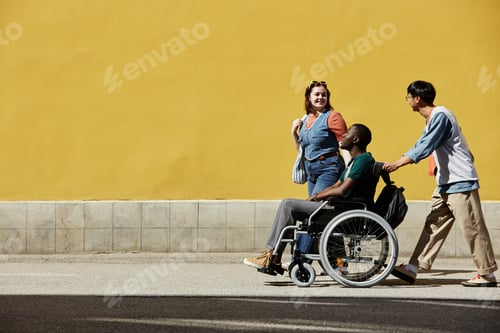 Preview: Wide Angle Group of Friends with Black Man using Wheelchair