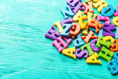 Preview: Multiple colored letters on wooden table