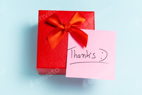 Preview: A red box with a red ribbon and a pink note that says "THANKS"