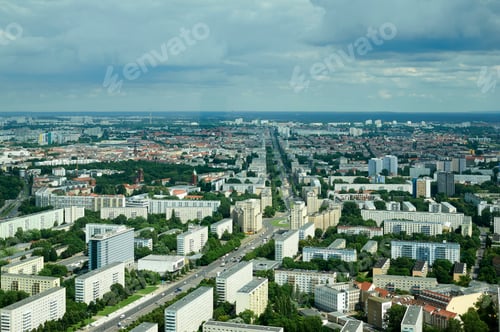 Preview: Aerial view of a cityscape with green areas, buildings, and a cloudy sky. Berlin, Germany