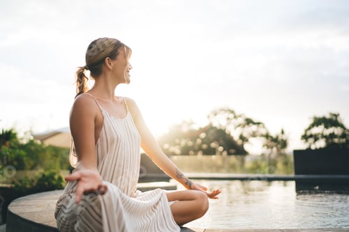 Preview: Girl practice yoga and meditate near swimming pool