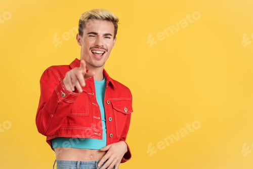 Preview: Stylish gay man laughing while pointing ahead