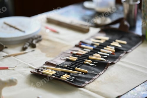 Preview: Various tools for pottery on table in workshop. Handicraft, creativity, hobby and activity concept.
