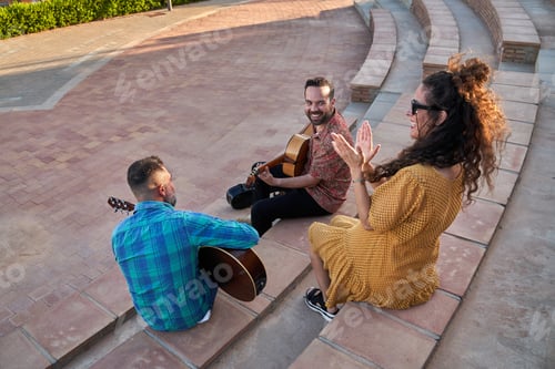 Preview: Musicians performing music in an outdoor amphitheater during day, female singer clapping hands