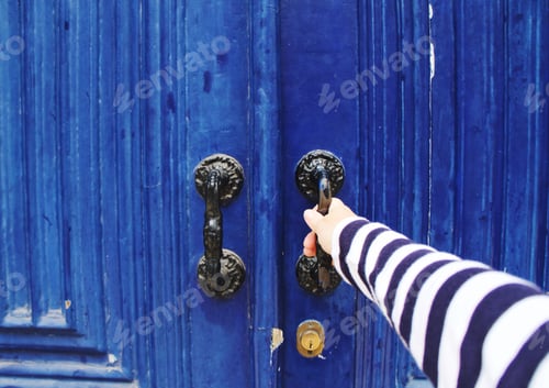 Preview: Hand opening blue wooden door