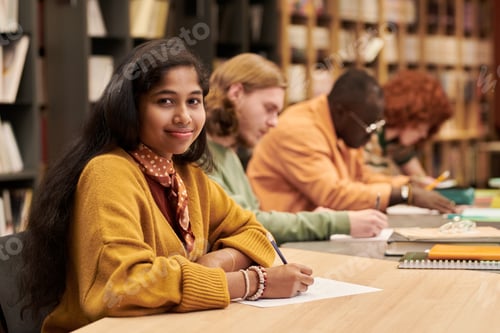 Preview: Portrait of Young Asian Woman Smiling While Studying in Library