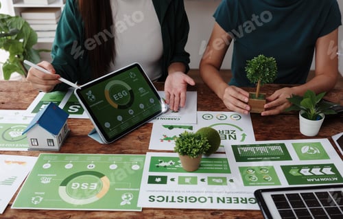 Preview: Businesswomen planning environmental social and governance strategy using tablet and charts