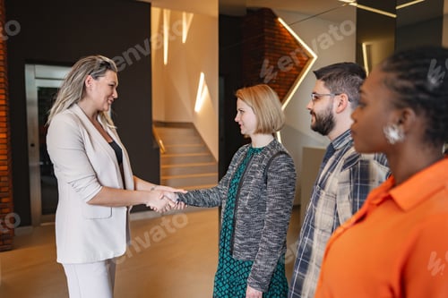 Preview: Group of People Standing Around Each Other Shaking Hands