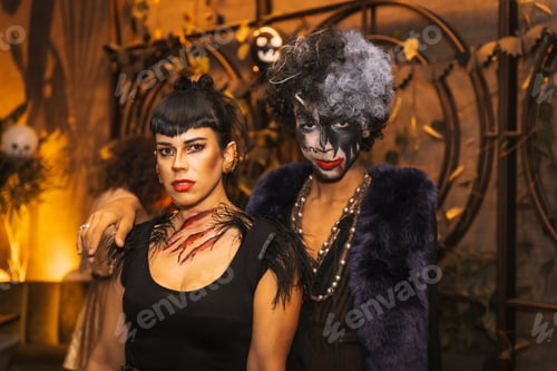 Preview: Portrait of friends costumes at halloween party with friends in disco nightclub, looking at camera