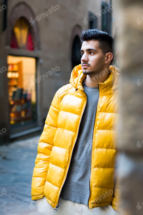 Preview: Young man wearing a yellow coat in Italy