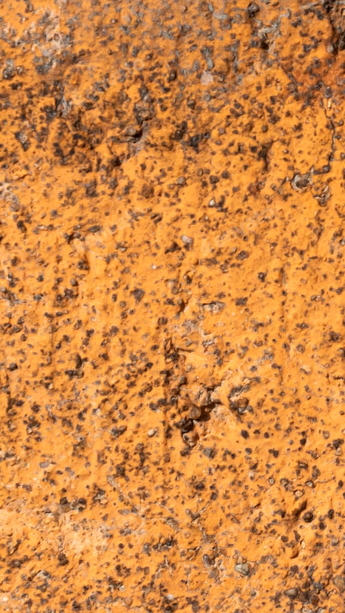 Preview: macro photo of an orange brick with visible texture. background