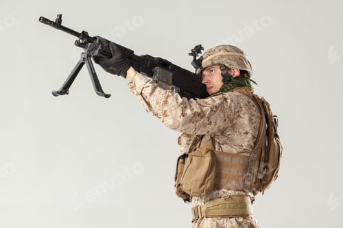 Preview: Soldier aiming a rifle during a training session in an indoor setting