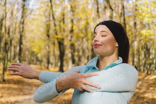 Preview: Girl doing fitness in nature on a sunny autumn forest
