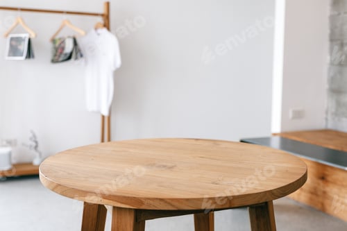 Preview: Closeup image of a wooden table and clothes rank in minimalist house
