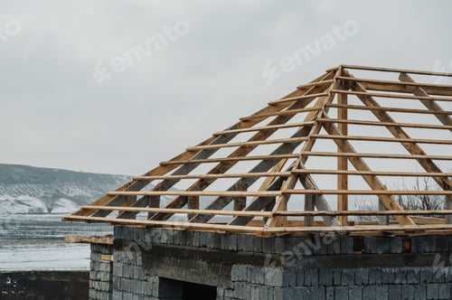Preview: A panoramic close-up shot of the roof of a house under construction against a blue sky background.