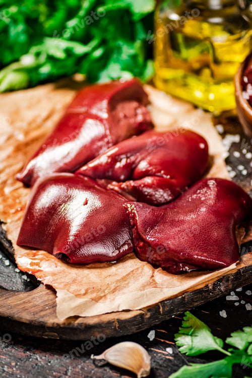 Preview: Pieces of raw liver with spices, oil and herbs.