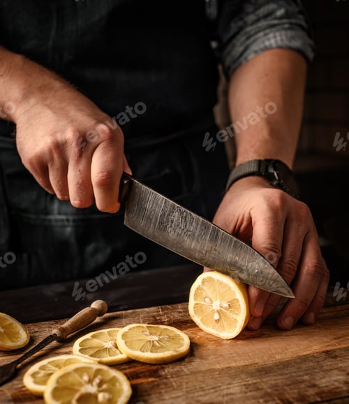 Preview: Chief hands cutting lemon to slices with knife