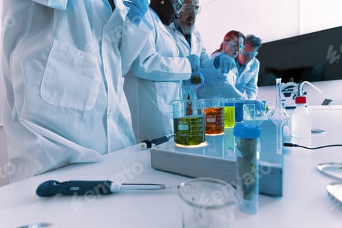 Preview: Scientific team performing chemical experiments in a modern research laboratory