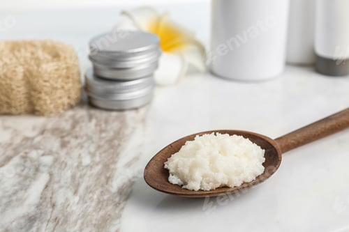 Preview: Spoon with Shea butter on marble table, closeup