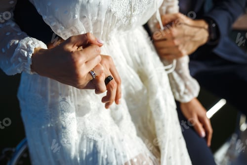 Preview: Bride and groom's hands with elegant wedding rings. Wedding details. Together. Wedding day.