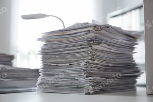 Preview: Stack of documents on desk in office