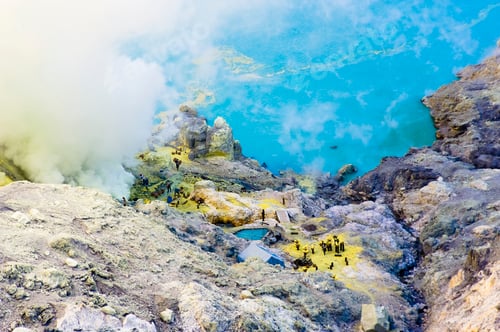Preview: Birds Eye View of Sulphur Miners Working by the Turquoise Acid Crater Lake at Kawah Ijen, Java, Indo