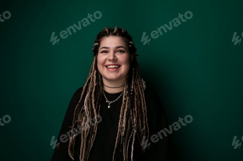 Preview: Woman With Dreadlocks Standing in Front of Green Wall