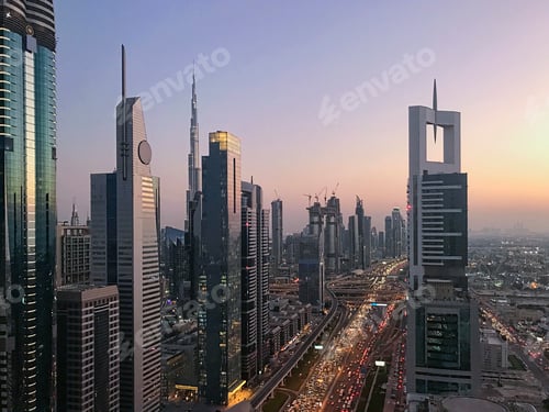 Preview: Beautiful sunset view with purple sky to futuristic city infrastructure and skylines buildings